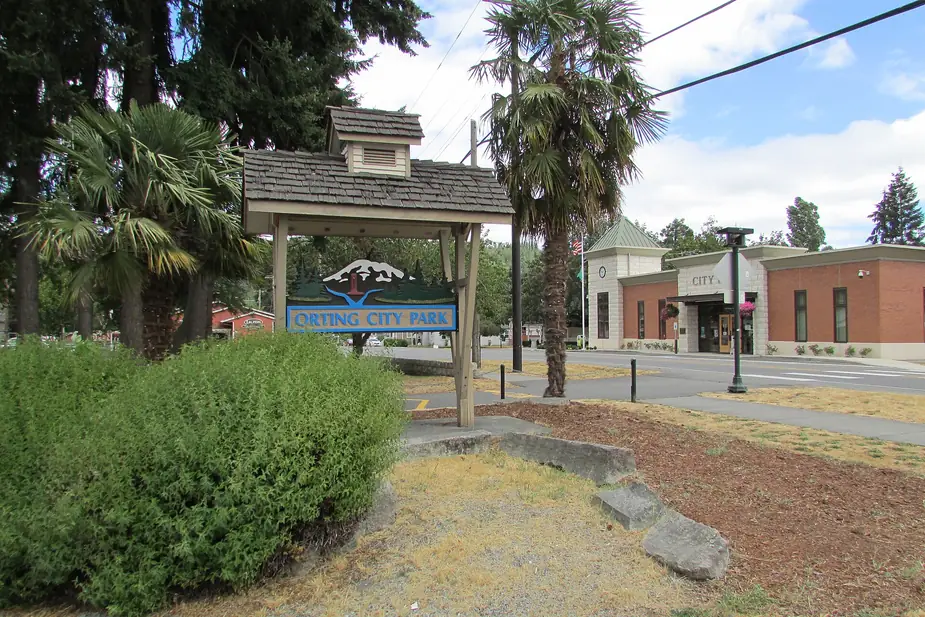 Orting City Park sign with the Orting city hall building beyond, Orting, Washington